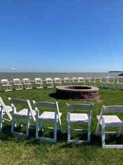 chairs and fire pit along the lake