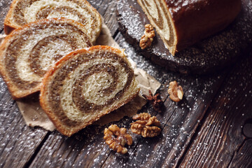 Walnut roll on a wooden background. Croatian orehnjaca