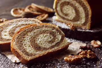 Walnut roll on a wooden background. Croatian orehnjaca
