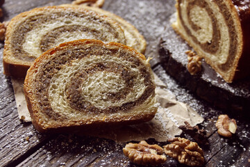 Walnut roll on a wooden background. Croatian orehnjaca