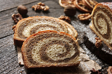 Walnut roll on a wooden background. Croatian orehnjaca