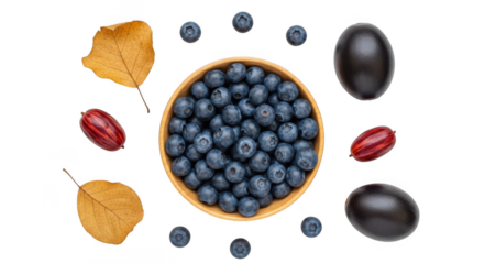 A bowl overflowing with fresh blueberries is surrounded by plump dark berries, striped fruits, and dry leaves isolated on transparent background