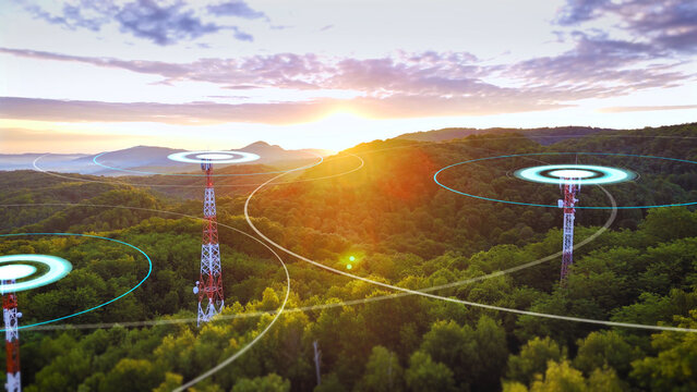 Communication towers emitting radio wave radiation at sunrise, symbolizing wireless signal and connectivity