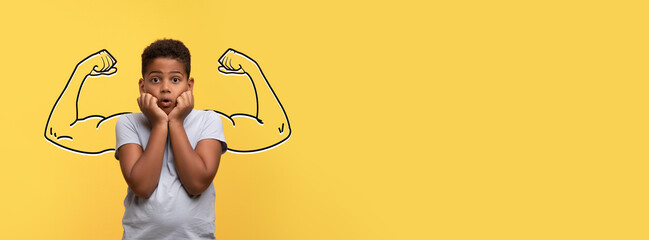 African American young boy stands with his hands on his cheeks, showcasing surprise. Behind him is...