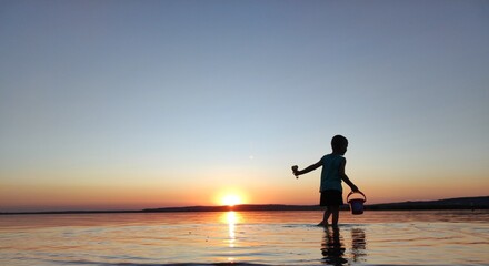 Fototapeta premium Child's Summer Sunset Adventure by the Lake