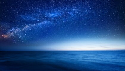 starry night sky in blue hues above a serene ocean seascape with ample copy space image