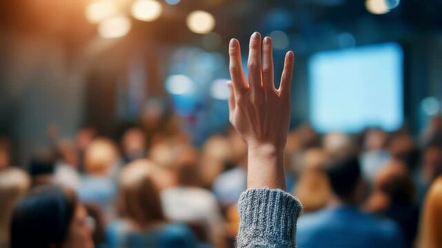 Medium shot focused on interactive polling screen displaying CSRD topics presenters hand in sharp detail with audience members and workshop environment softly blurred.