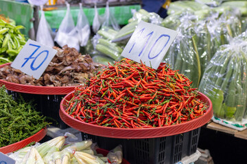 A Vibrant and Bustling Market Scene Featuring Fresh Red Chilies and Various Vegetables