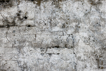 Cement wall texture with pebbles, white paint, layers, earth reinforcement, full-frame background.