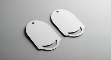 Two blank white merchandise tags with a unique die-cut handle, presented as a clean mockup template for branding and retail design on a gray background