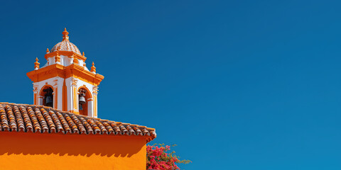 Naklejka premium Colorful church tower rising against vibrant blue sky in seville