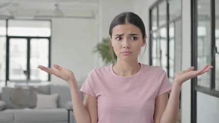 Candid moment of young woman in a modern living space, expressing confusion or contemplation with her hands on her head. - Powered by Adobe