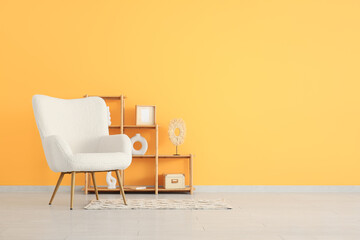 Cozy armchair and shelving units near yellow wall