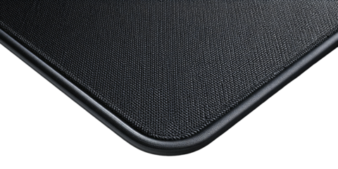 Close-up of a black textured surface with a dark metallic edge