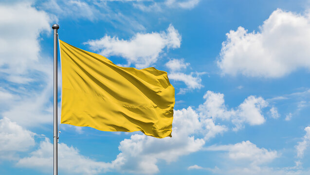 Yellow Flag Waving Against Bright Blue Sky with Fluffy Clouds, Symbol of Caution or Alert