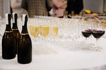 Elegant wine and champagne glasses on banquet table at luxury event or wedding reception