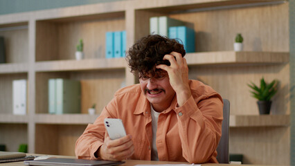 Angry man businessman Caucasian guy male business investor using mobile phone in office online bet...