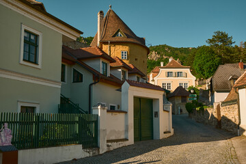 Charming street view in Dürnstein, Austria, with colorful historic houses and cobblestone pavement. Picturesque medieval town in the Wachau Valley.