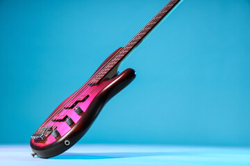 Modern red electric guitar on blue background