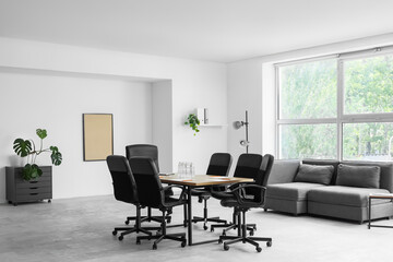 Interior of conference hall with table, lamp and sofa