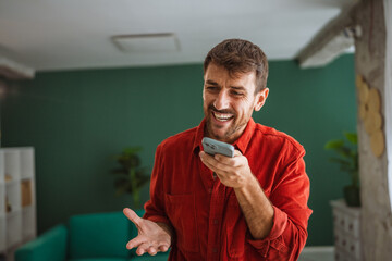 Start up founder recording a voice message in his office