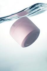 Pink cosmetic jar underwater