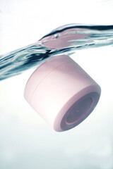 Pink cosmetic jar underwater