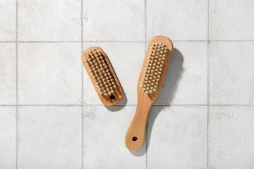 Fototapeta na wymiar Body massage brushes on white tile background
