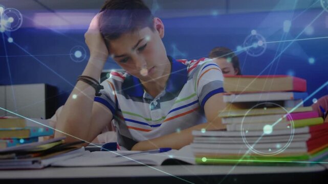 Teenage boy studying, girl reading in school while digital network overlay fading in linking books