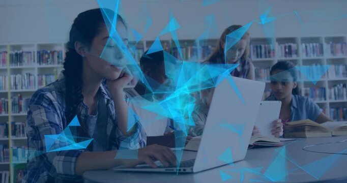 Students at round library table initiating digital learning network while typing on laptop