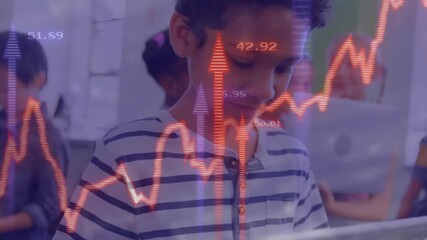 Child boy tapping tablet screen in classroom activating red finance graphs over peers laptops - Powered by Adobe