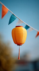 Obraz premium Traditional festa junina paper lantern with colorful bunting against blue sky