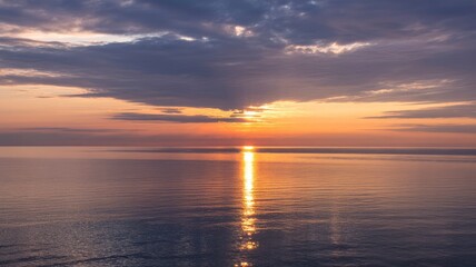 Naklejka premium Serene Sunset over Calm Ocean Waters