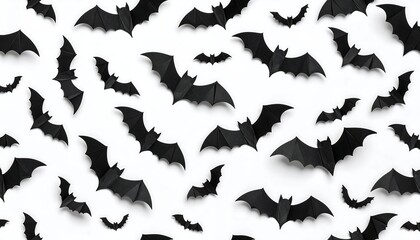 A seamless pattern of black paper bats against a white background.  Symmetrical, flat lay