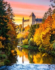 Naklejka premium Autumn castle by a river at sunrise
