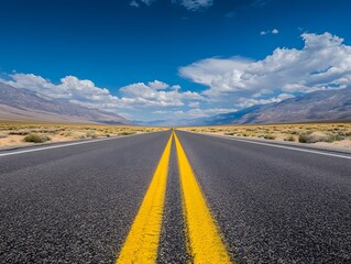 Fototapeta premium Endless Desert Road Adventure: Scenic Highway Journey Under Blue Sky and White Clouds