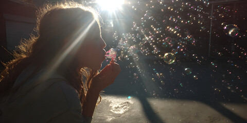 Joyful Child Blowing Bubbles in a Sunlit Backyard