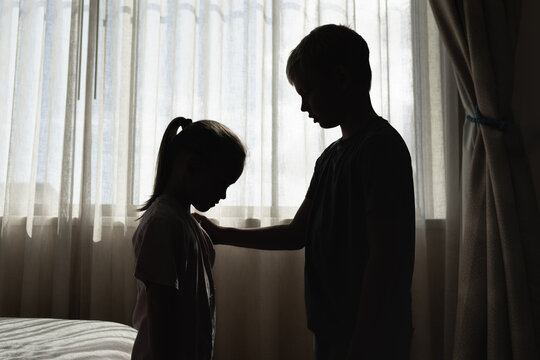 Brother comforting helping his crying sad upset sister children showing kindness and empathy. Family relationships frendship concept	