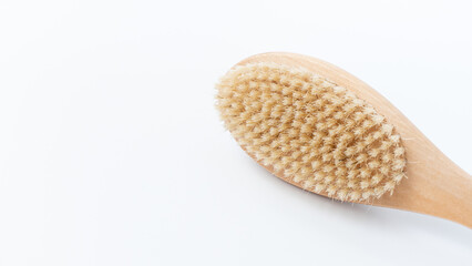 Wooden cellulite treatment brush with natural bristles, showcasing ergonomic design and texture for effective skin care and body wellness routines