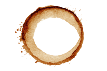 Circular coffee stain.  A perfect ring of light brown stain, with a dark center hole, against a black background.  Splashes and irregularities in the stain's outer edge