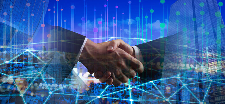 Business people shaking hands, multiple exposure with cityscape and buildings. Success in partnership, deal, agreement. Banner design