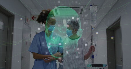 Walking patient gripping IV pole with nurse guiding in hospital corridor, digital face scan overlay