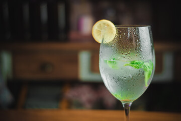 Mojito cocktail prepared on a table with a blurred background.