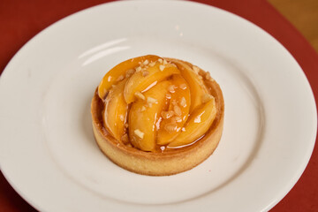 Enjoy a Delicious Apple Tart with Glaze and Almonds, perfect for any elegant occasion