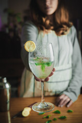 Female bartender making a mojito cocktail.