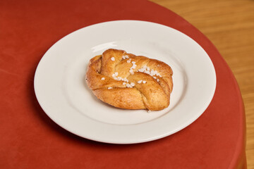 A freshly baked pastry displayed beautifully on a pristine white plate, ready to enjoy