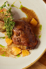 Gourmet Display of Succulent, Savory Meat Accompanied by Citrus Fruits and Aromatic Herbs