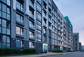 Obraz premium New modern block of flats in green area at night. residential apartment with flat buildings exterior. luxury house complex. Part of City Real estate property, condo architecture. apartment
