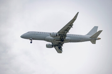 Passenger airplane flying in the sky during landing approach