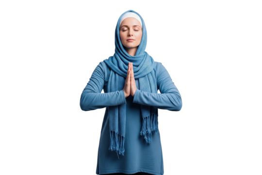Peaceful Muslim woman in a blue hijab praying with her hands together.